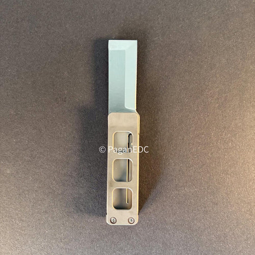 Petrified Fish PFE09 Cash titanium front flipper knife with 14C28N satin blade on dark background