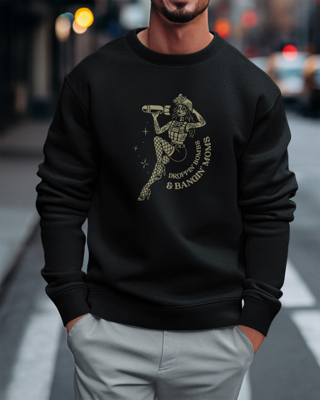 Person wearing a black sweatshirt with a graphic design on a city street.