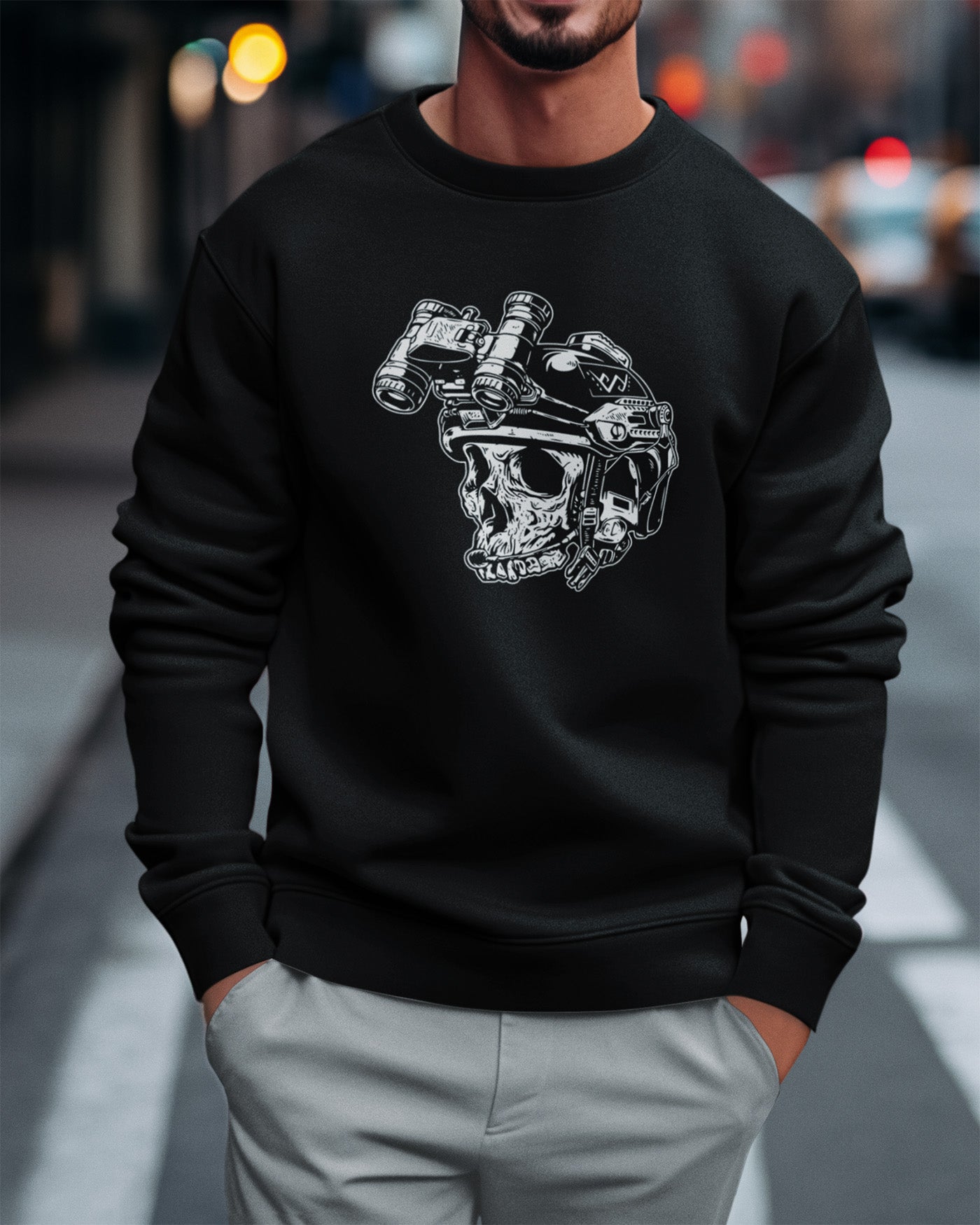 Person wearing a black sweatshirt with a graphic design of a skull wearing a helmet.