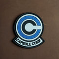 PVC patch of the Capsule Corp. logo in white, black, and blue