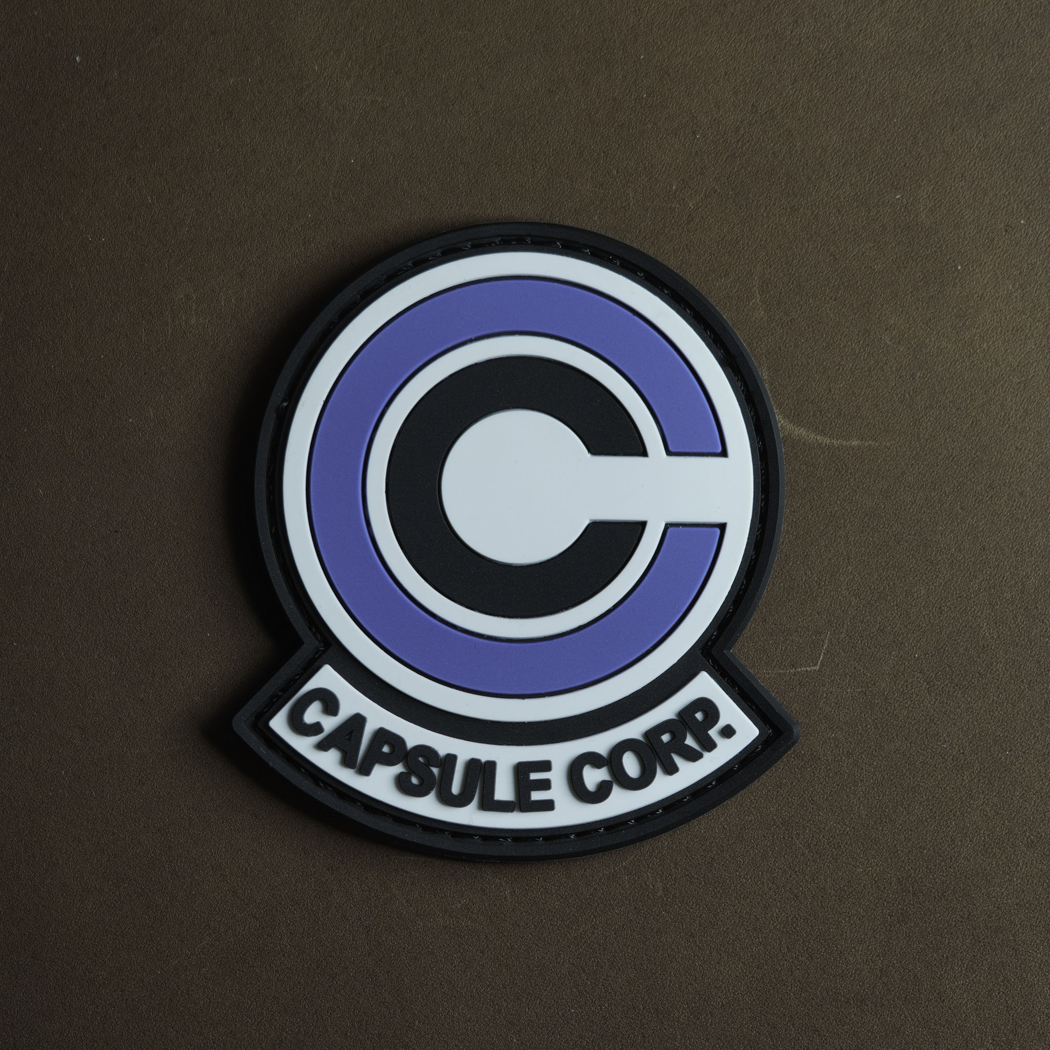 PVC patch of the Capsule Corp. logo in white, black, and blue