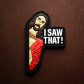 PVC patch showing a stylized religious figure peeking with the words “I SAW THAT!” on a black background.