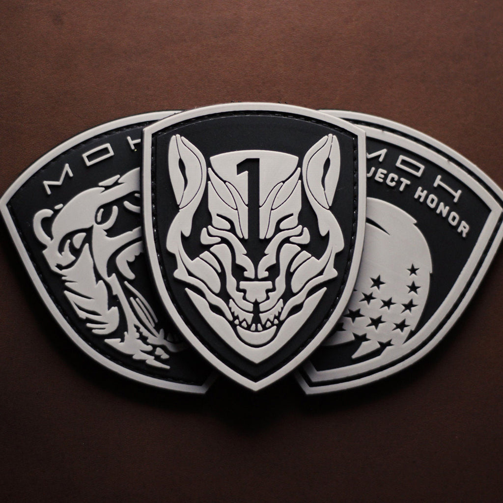 “MOH” PVC patch with wolf and shield design on brown background