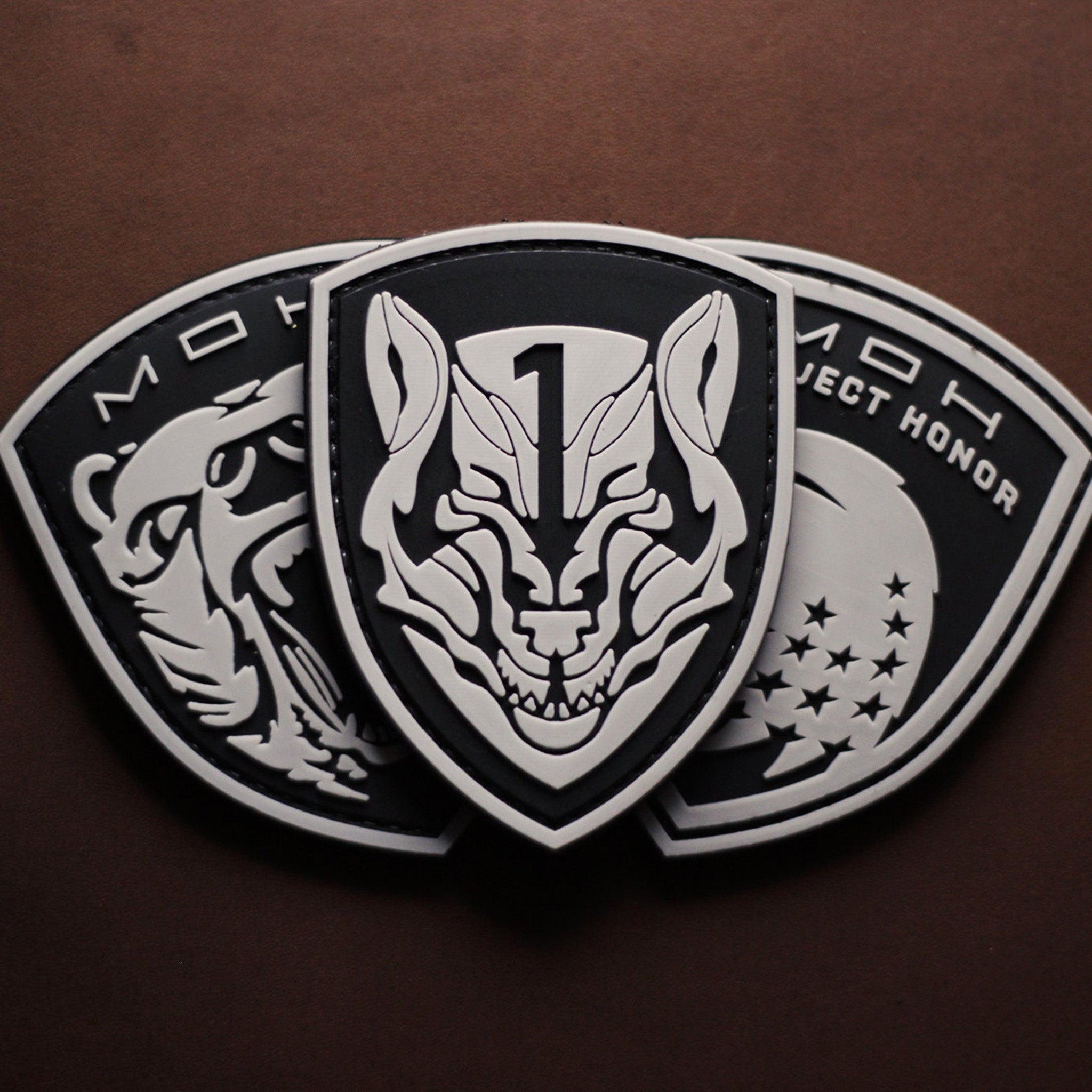 “MOH” PVC patch with wolf and shield design on brown background