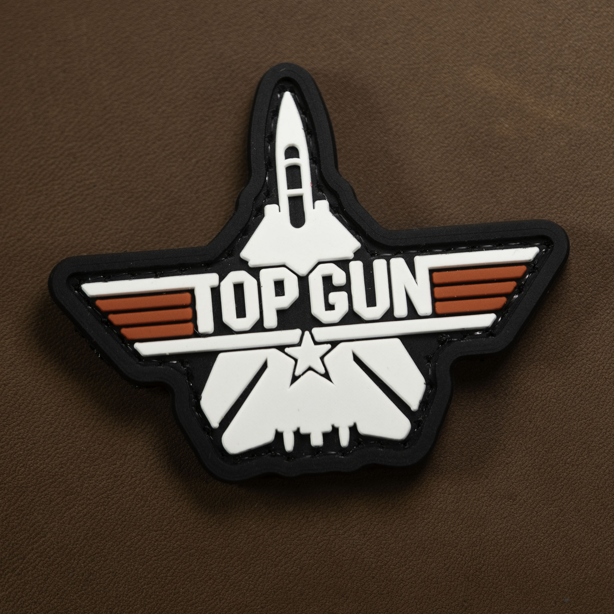 Top Gun logo patch on a brown background