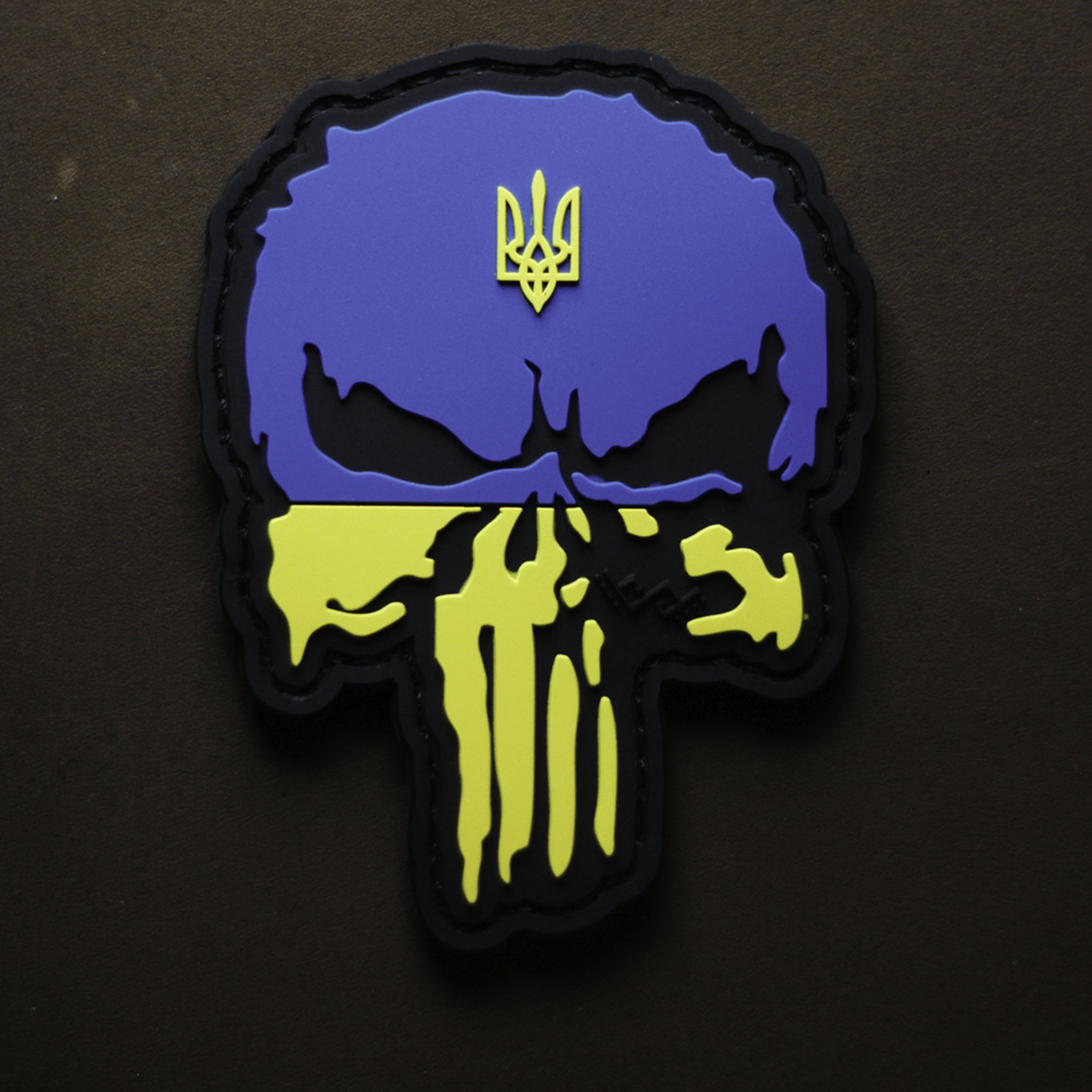 PVC patch featuring a Punisher skull design in Ukrainian flag colors with a trident emblem.