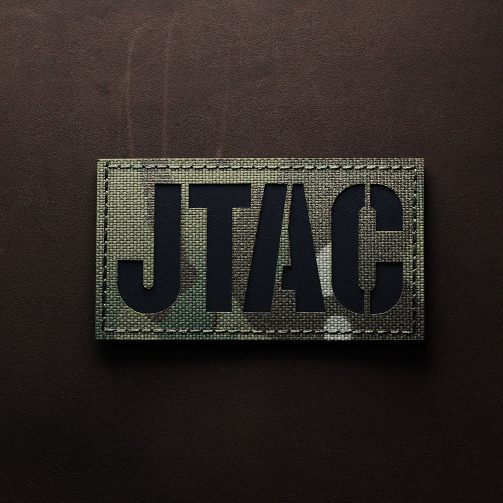 Camouflage JTAC laser-cut patch with black lettering displayed on a dark surface.