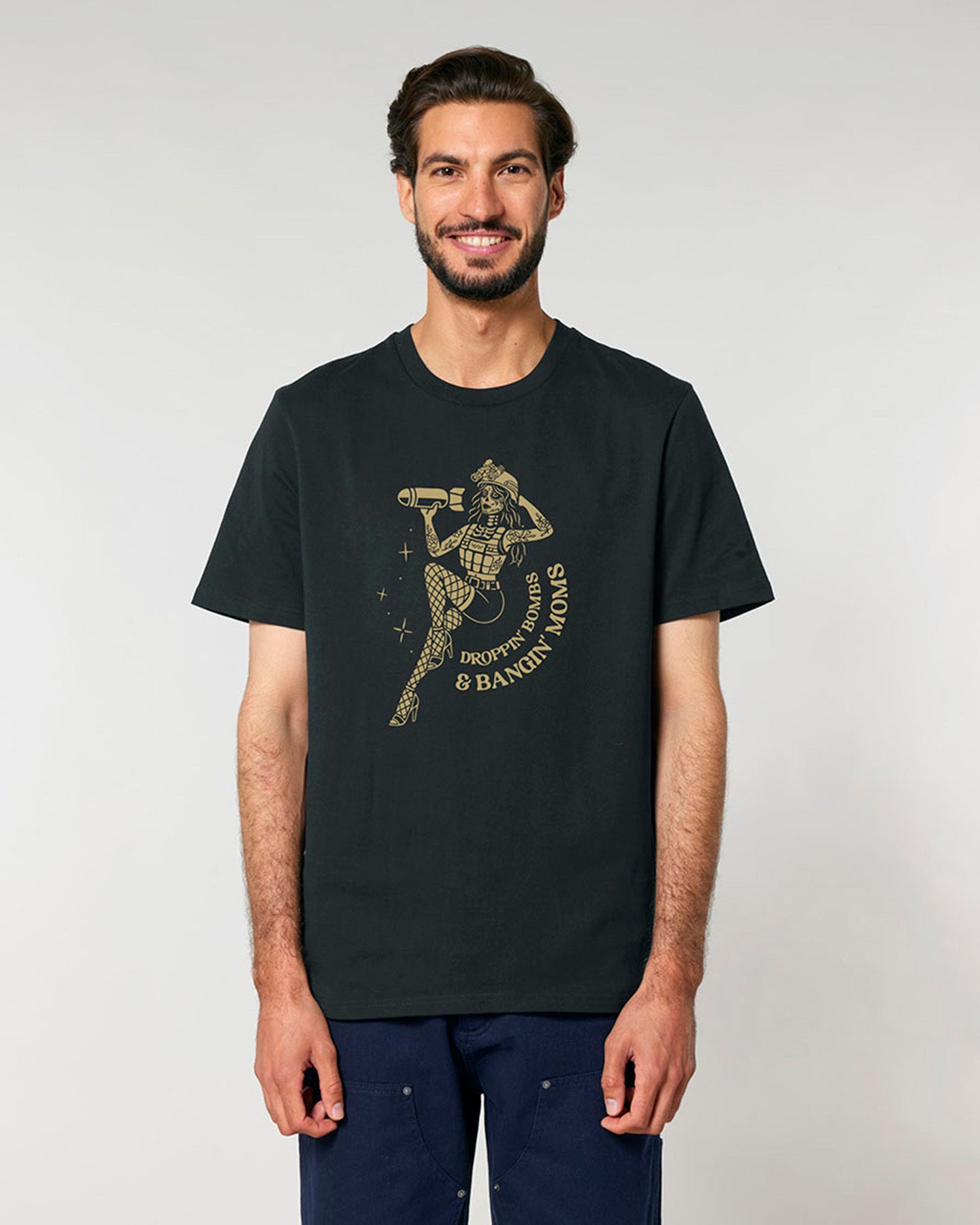 Man wearing a black t-shirt with a graphic design on a plain background